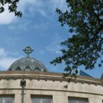 Beautiful view of a church dome framed by tree branches under a blue sky in Fort Worth, Texas.
