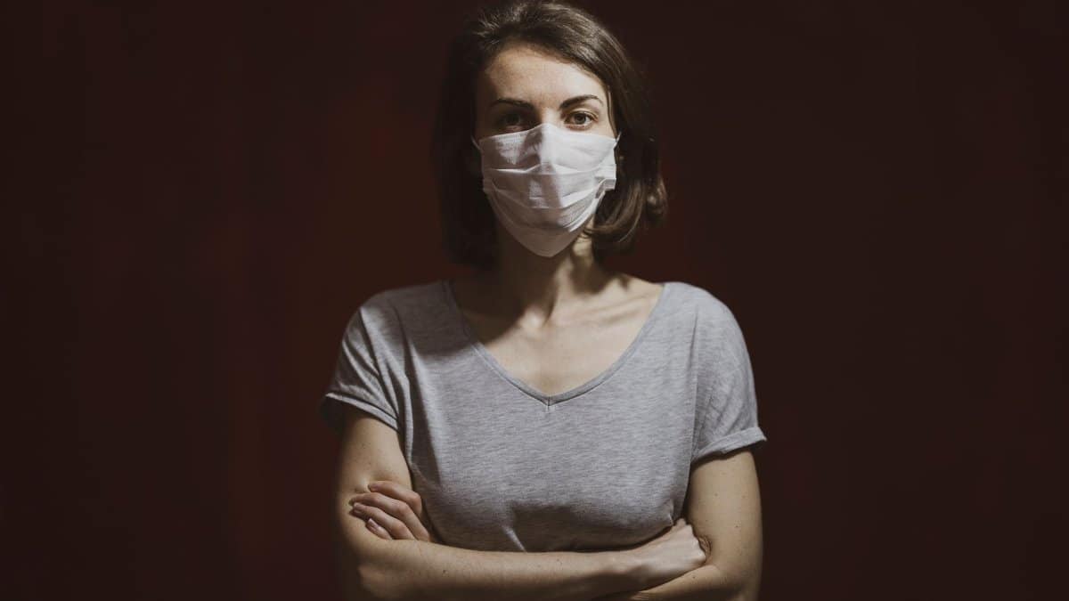 Studio portrait of a woman wearing a face mask. Concept of health, pandemic, and protection.