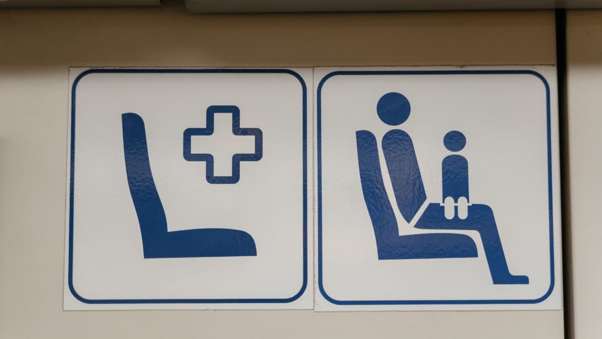 Blue pictogram signs indicating reserved seating on public transport.