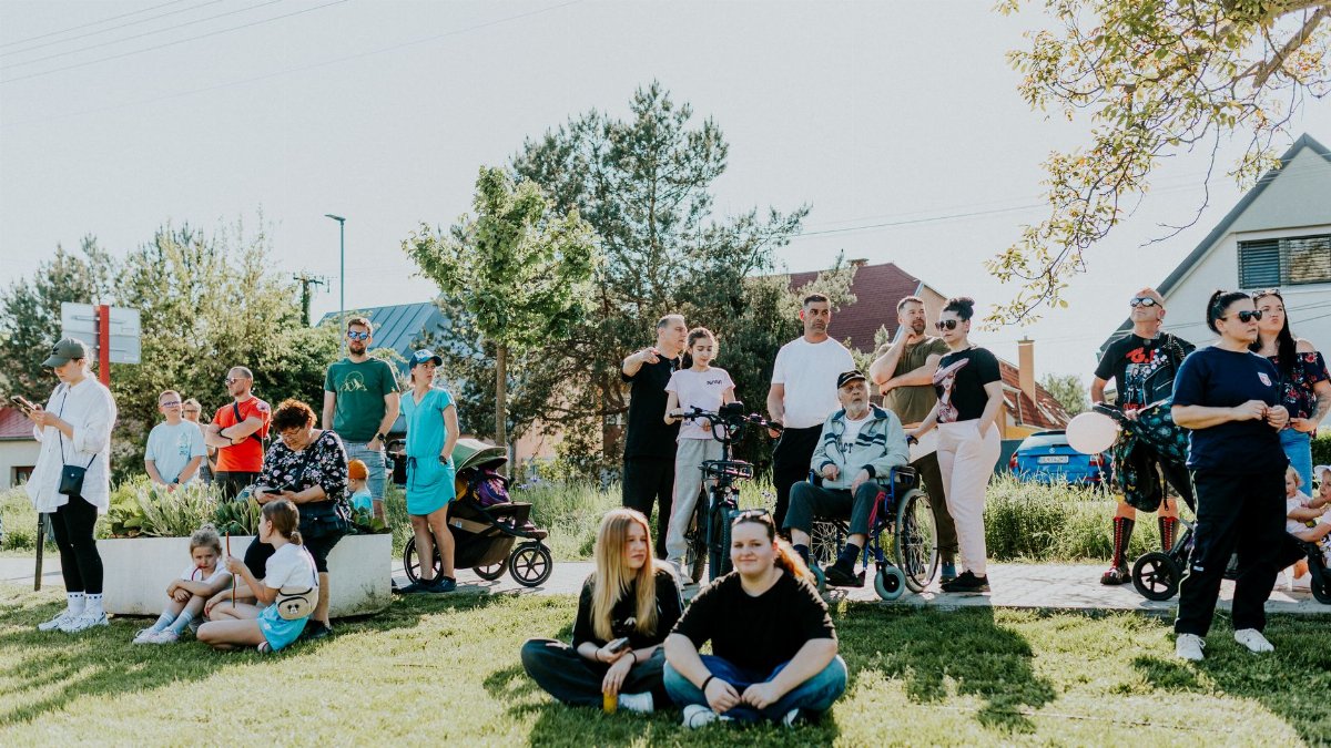 A diverse group enjoying a sunny day outdoors, showcasing community and togetherness.