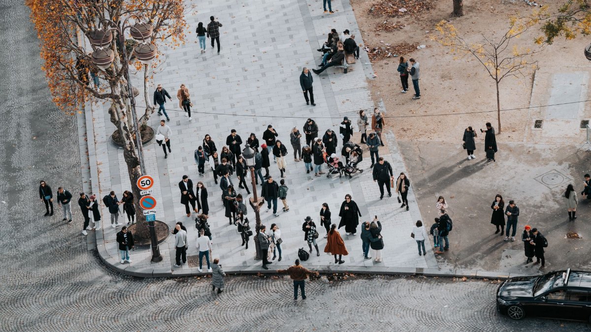 Crowd of people on a street in Paris during autumn from above view.
