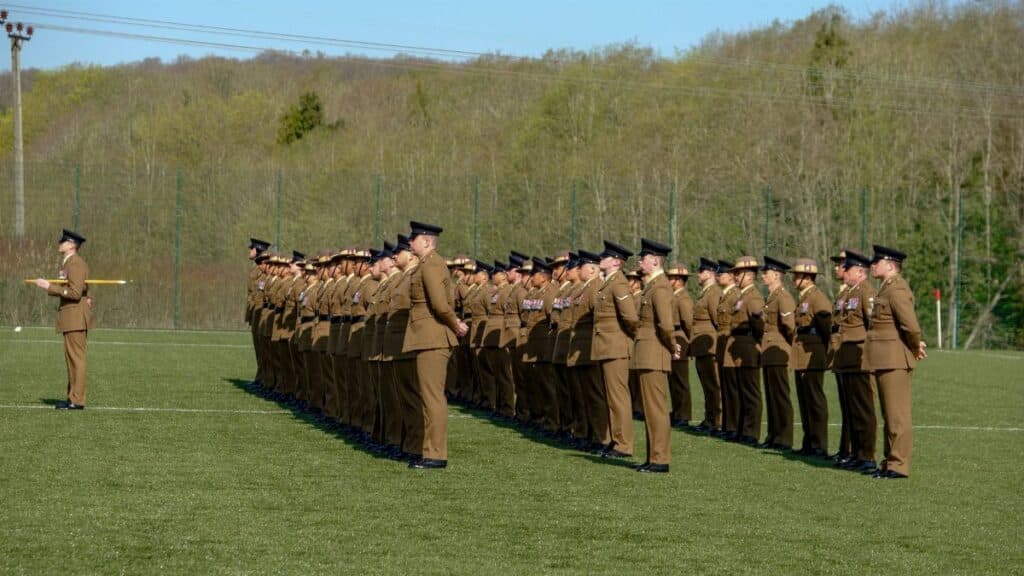 British soldiers standing in formation during a military ceremony at Perham Down, England outdoors.