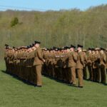 British soldiers standing in formation during a military ceremony at Perham Down, England outdoors.