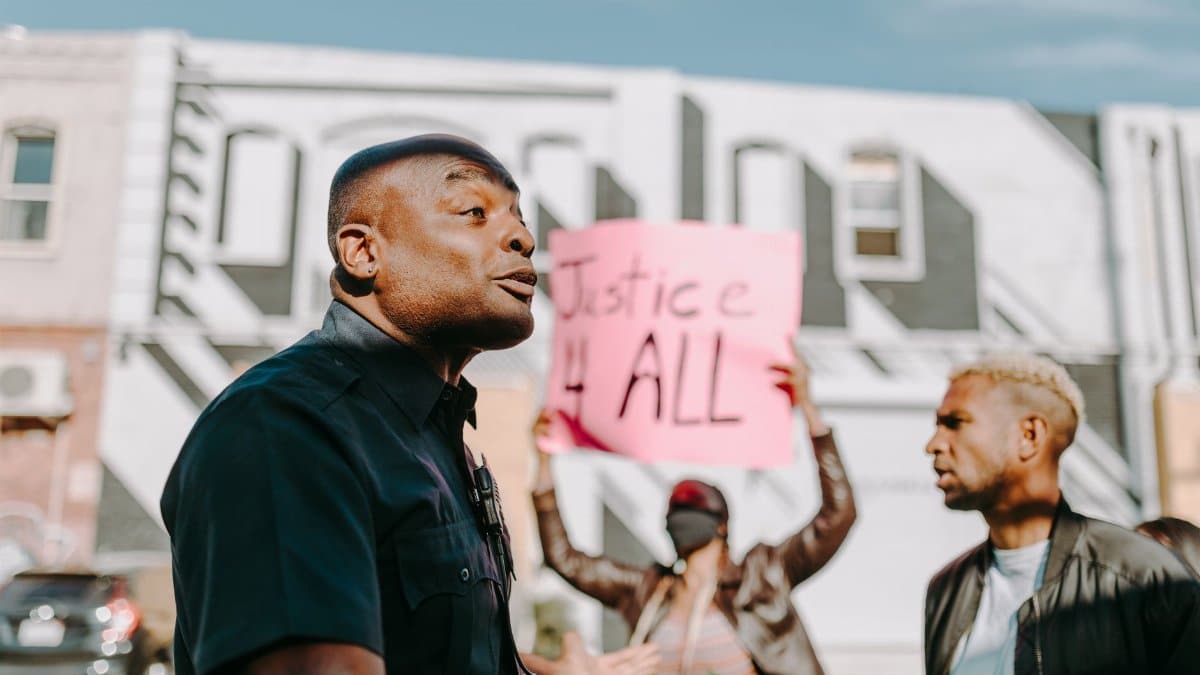 Protesters rallying for justice and equality in a city setting.