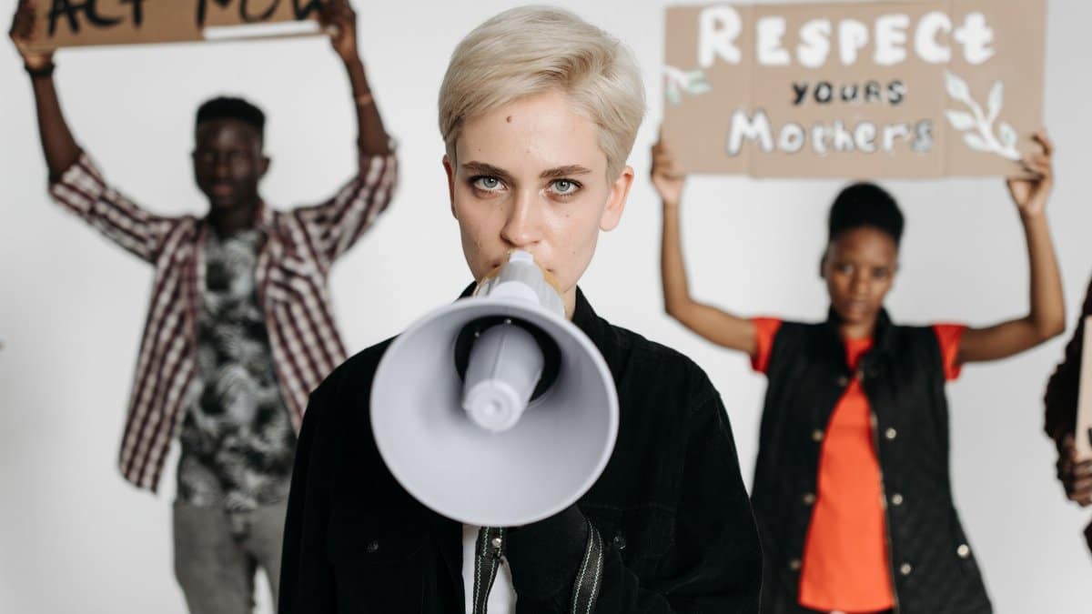 Group of protesters holding signs and megaphones advocating for change.