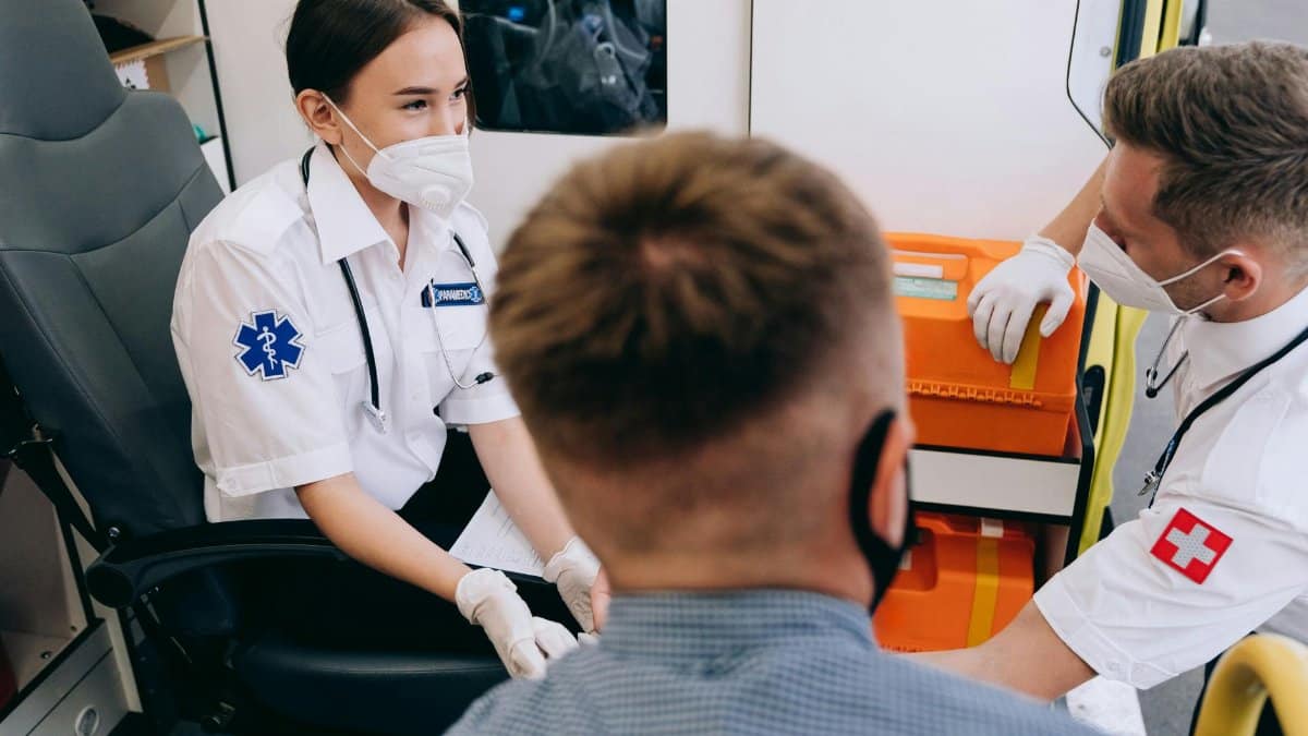 Medical professionals in action inside an ambulance, attending to a patient with care.