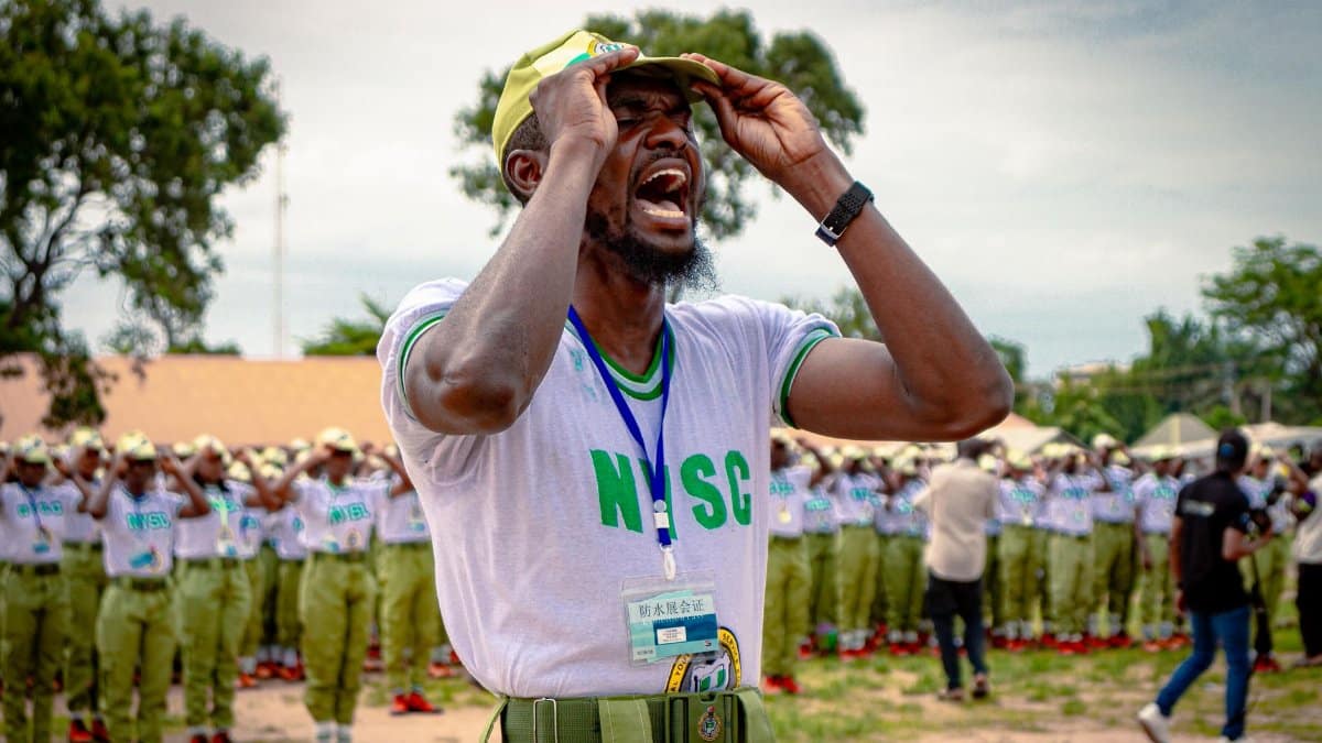 NYSC member passionately leads a drill session in Kaduna, Nigeria, showcasing teamwork and youth empowerment.