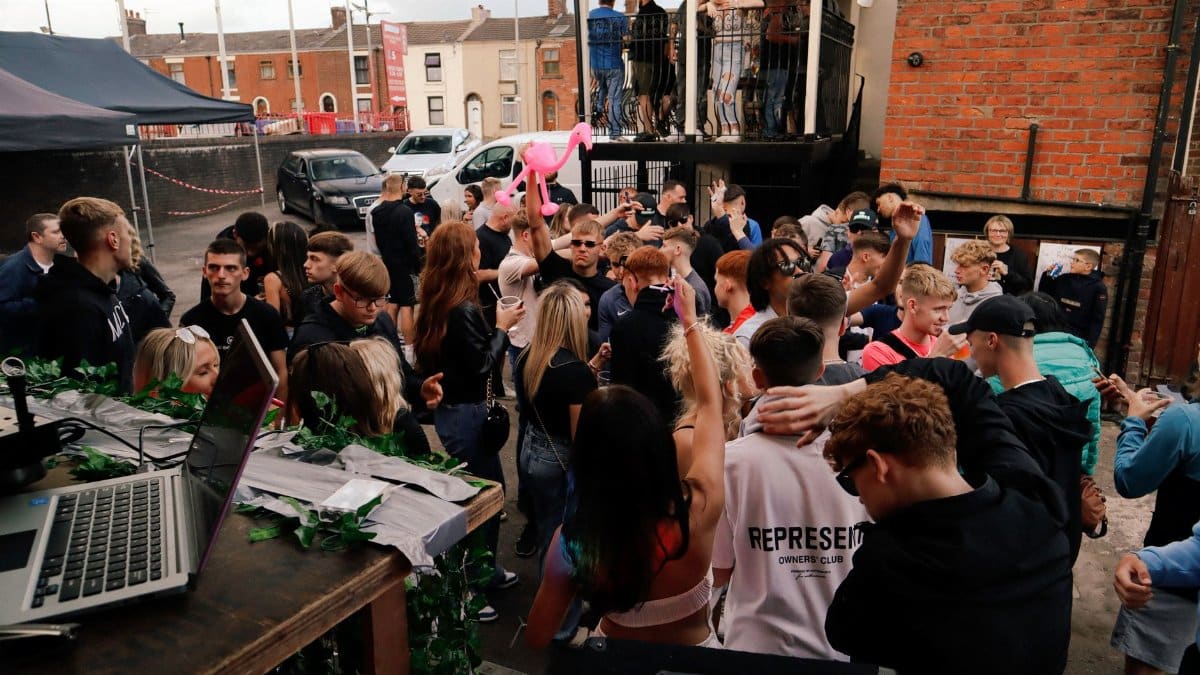 Energetic outdoor party scene with people dancing and socializing, perfect for event promotions.