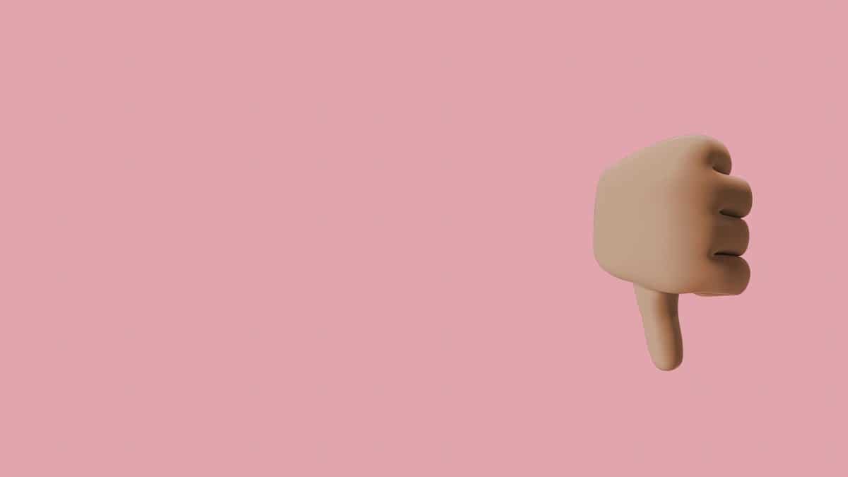 3D thumbs down gesture with a pink background providing ample copy space.