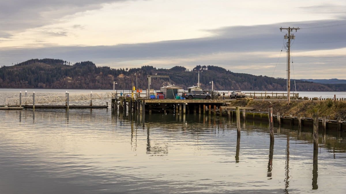 A tranquil view of the dock at Tokeland, WA, under cloudy skies with calm waters.