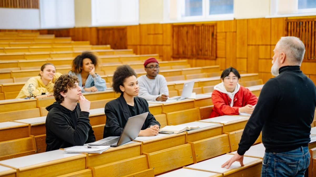 University students engaging in a diverse classroom setting with a lecturer.