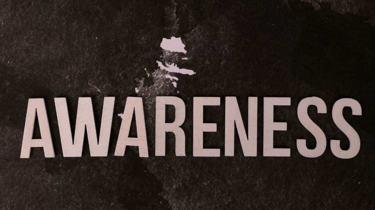 Text 'Awareness' on a dark textured backdrop promotes mindfulness and social causes.