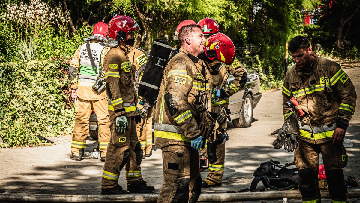 Firefighters take a break during emergency operation in Wrocław, Poland.