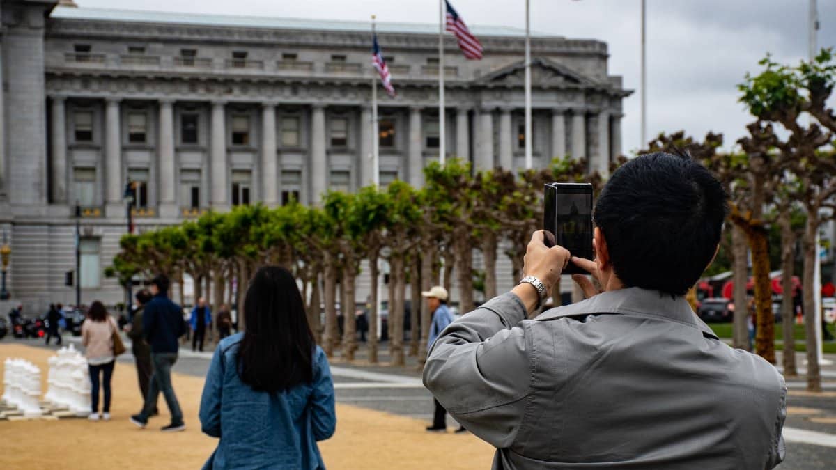 People photographing the Civic Center in San Francisco, showcasing urban architecture and city life.