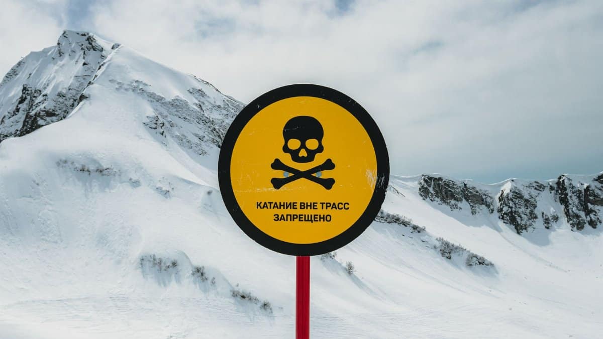 Ski warning sign against skiing off trails in Красная Поляна, Russia landscape.