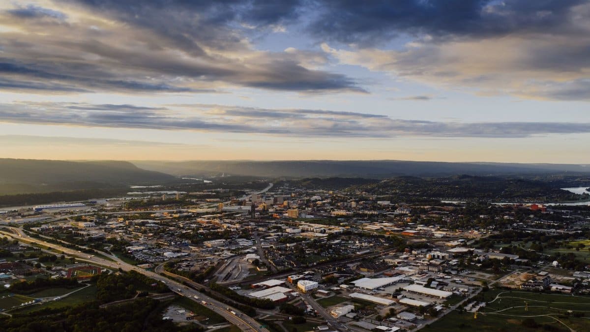 Stunning aerial view of Chattanooga, Tennessee, capturing the city's skyline and surrounding landscapes at dusk.
