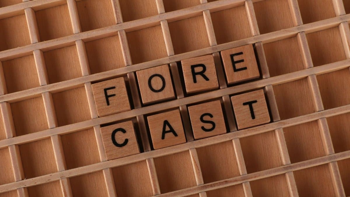 Wooden tiles spelling 'forecast' arranged on a wooden grid, perfect for business or prediction themes.