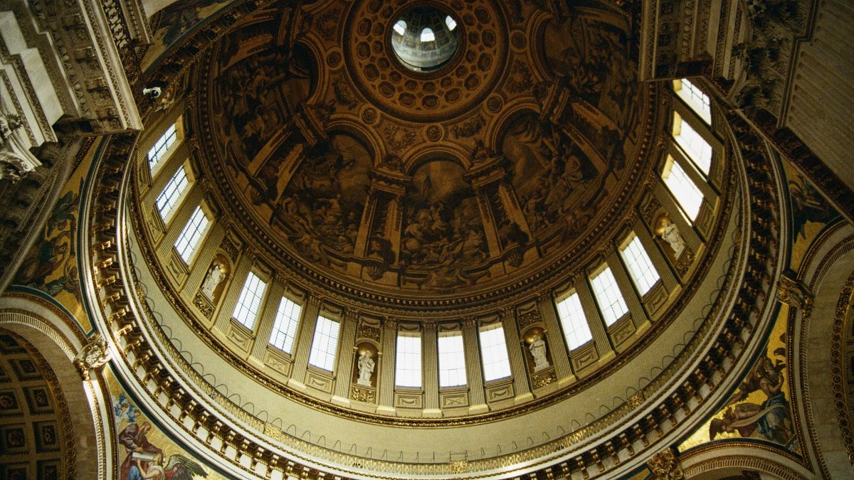 Intricate interior view of St. Paul's Cathedral dome in London, showcasing stunning architectural details.