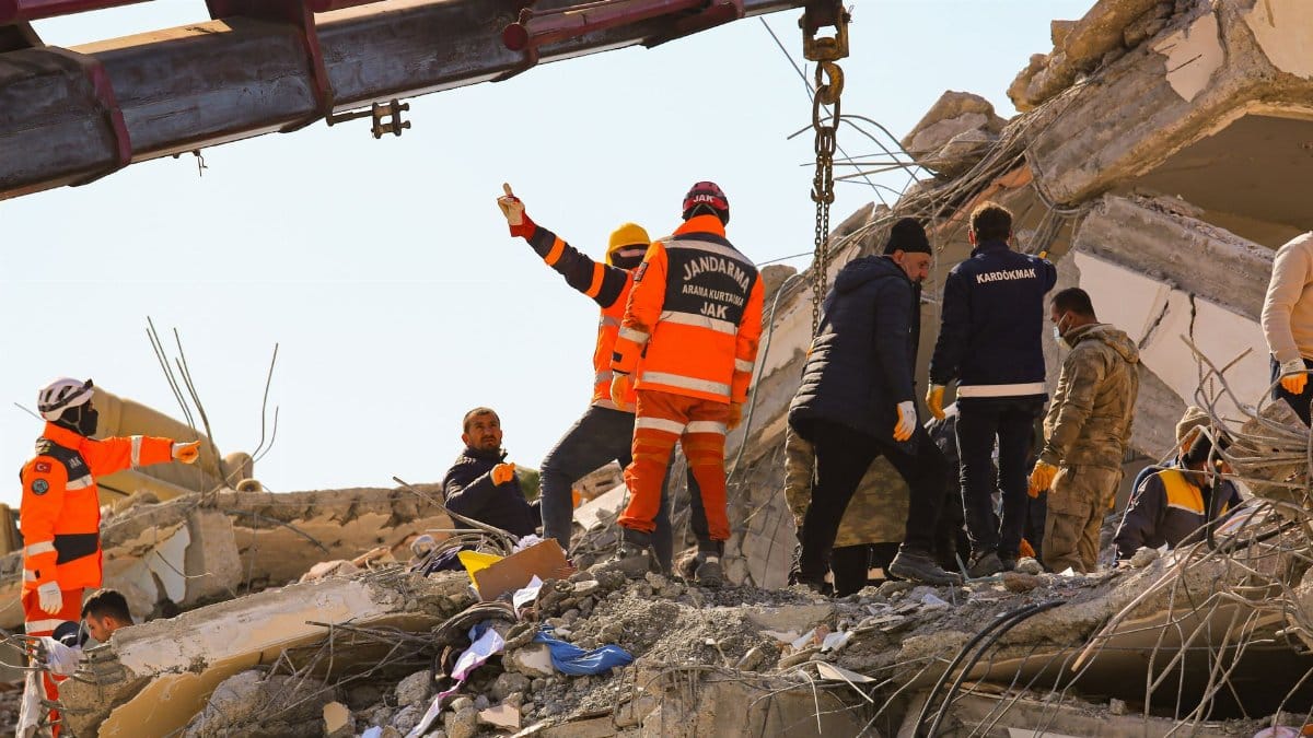 Rescue workers searching through rubble after an earthquake, showcasing teamwork and determination.