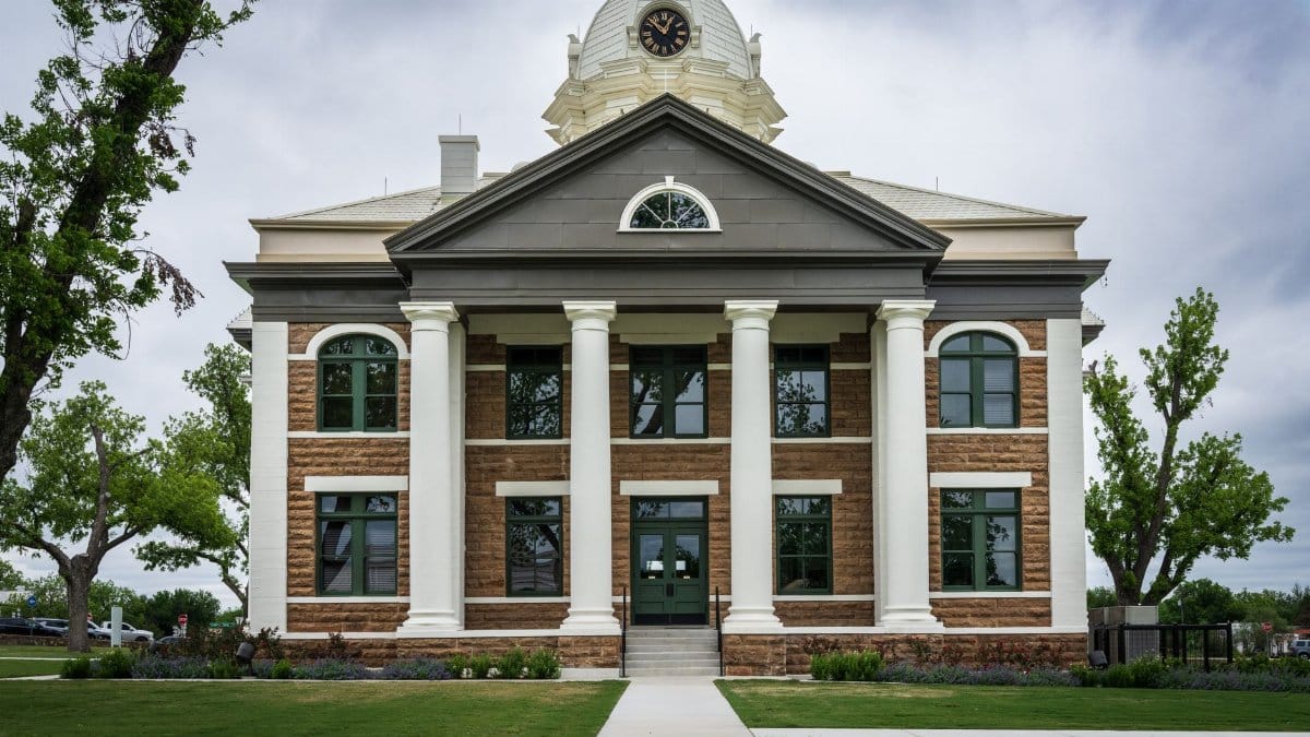 Classic architectural design of Mason County Courthouse, Texas amid lush greenery.