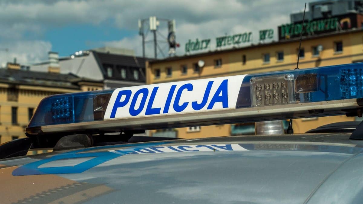 Close-up of Polish police car light bar with buildings in the background.