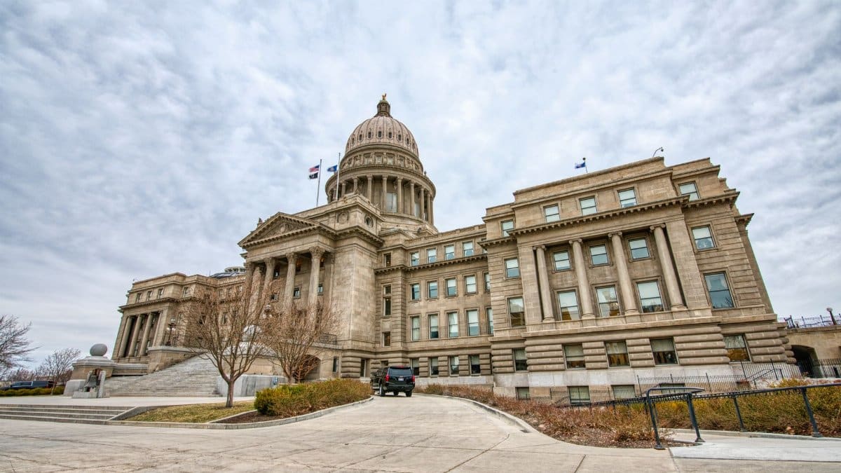 Majestic view of the Idaho State Capitol with its iconic dome under a cloudy sky.