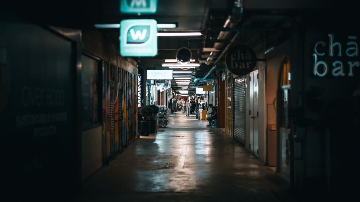 Dimly lit corridor in a Thai shopping center, capturing a moody urban atmosphere.