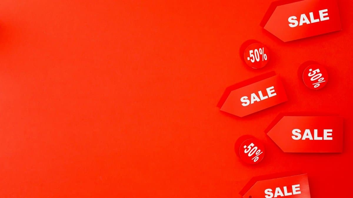 Red sale tags with 50% discounts on vibrant background for retail promotions.