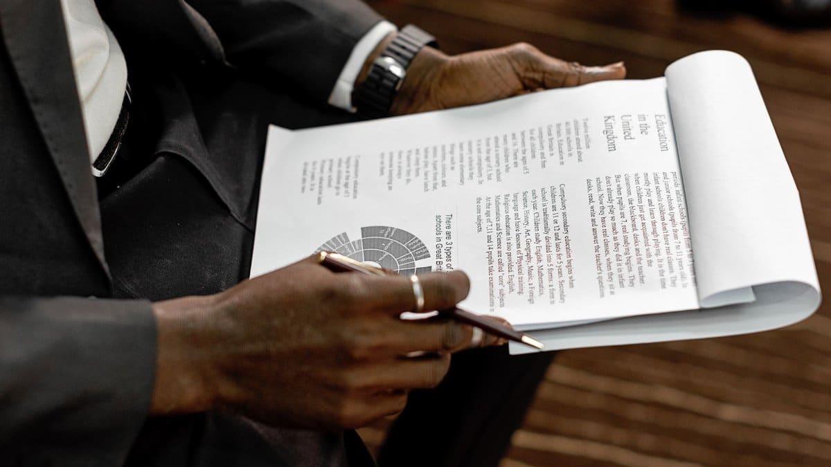 Business professional reviewing financial documents with charts and graphs during a meeting.