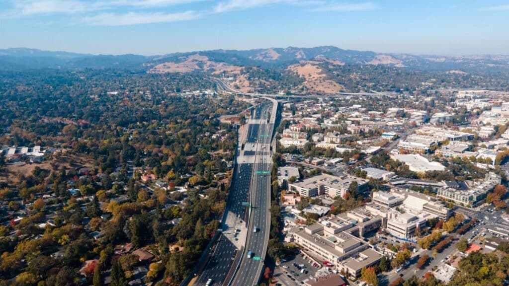 Aerial view capturing the sprawling suburbs and highway of Walnut Creek, California