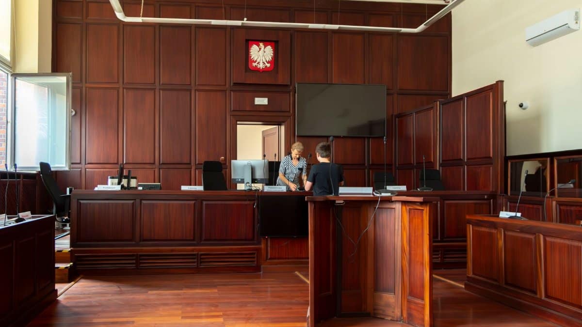 Spacious Polish courtroom with wooden panels and furniture located in Wrocław, Lower Silesia.