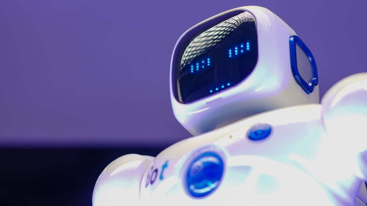 A modern humanoid robot with digital face and luminescent screen, symbolizing innovation in technology.