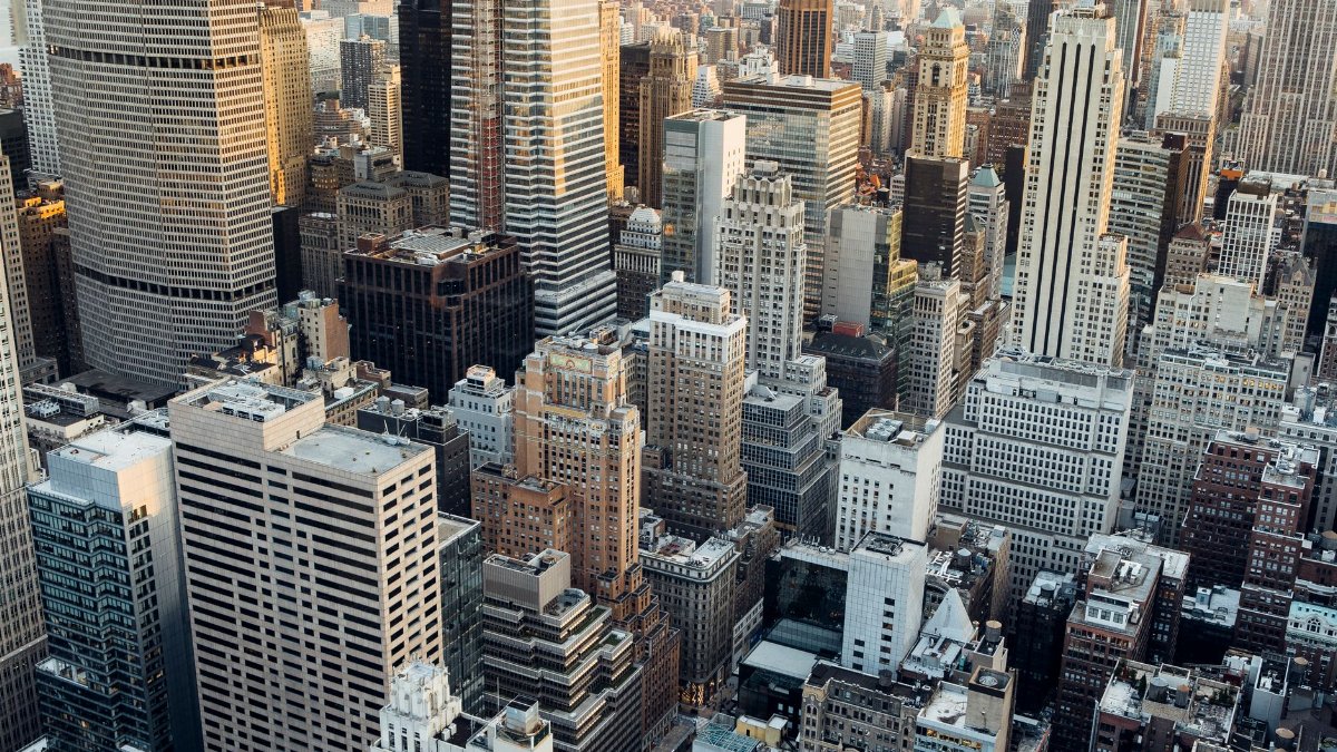 From above of high rise skyscrapers and residential buildings placed in downtown of New York City in daylight