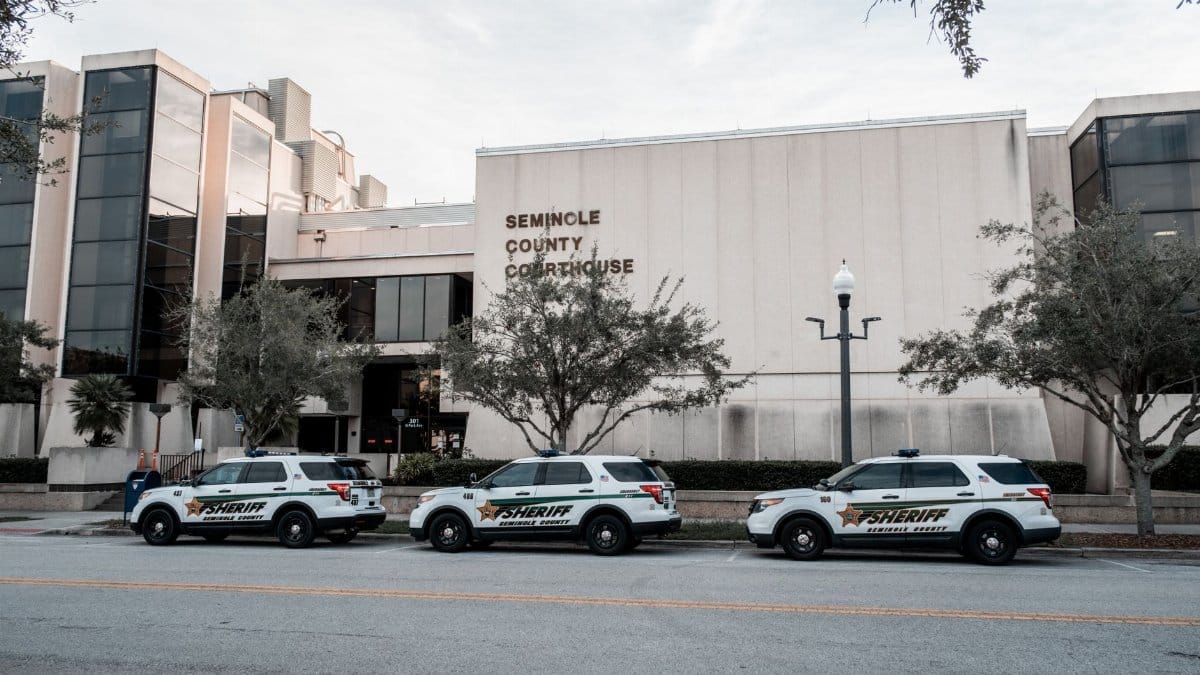 Sheriff vehicles parked in front of Seminole County Courthouse during the day.