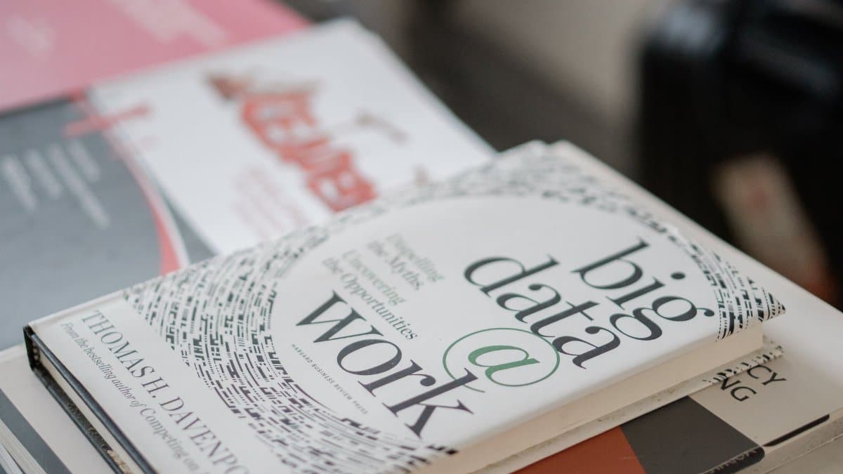 Close-up of books on data analytics and business strategies on a desk.
