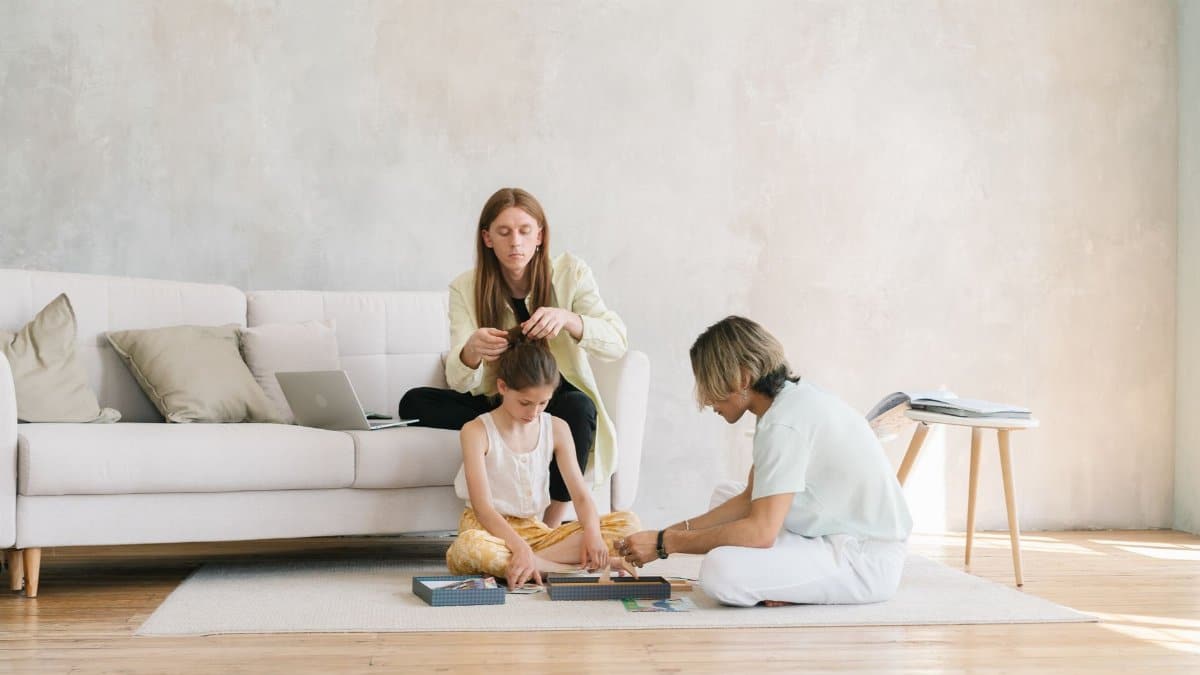 A family enjoying quality time together indoors, playing and bonding in a cozy living room.