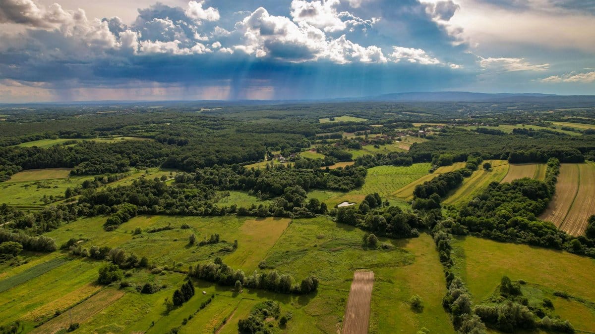 Stunning aerial shot of Garešnica, Croatia showcasing vibrant fields and dramatic skies.