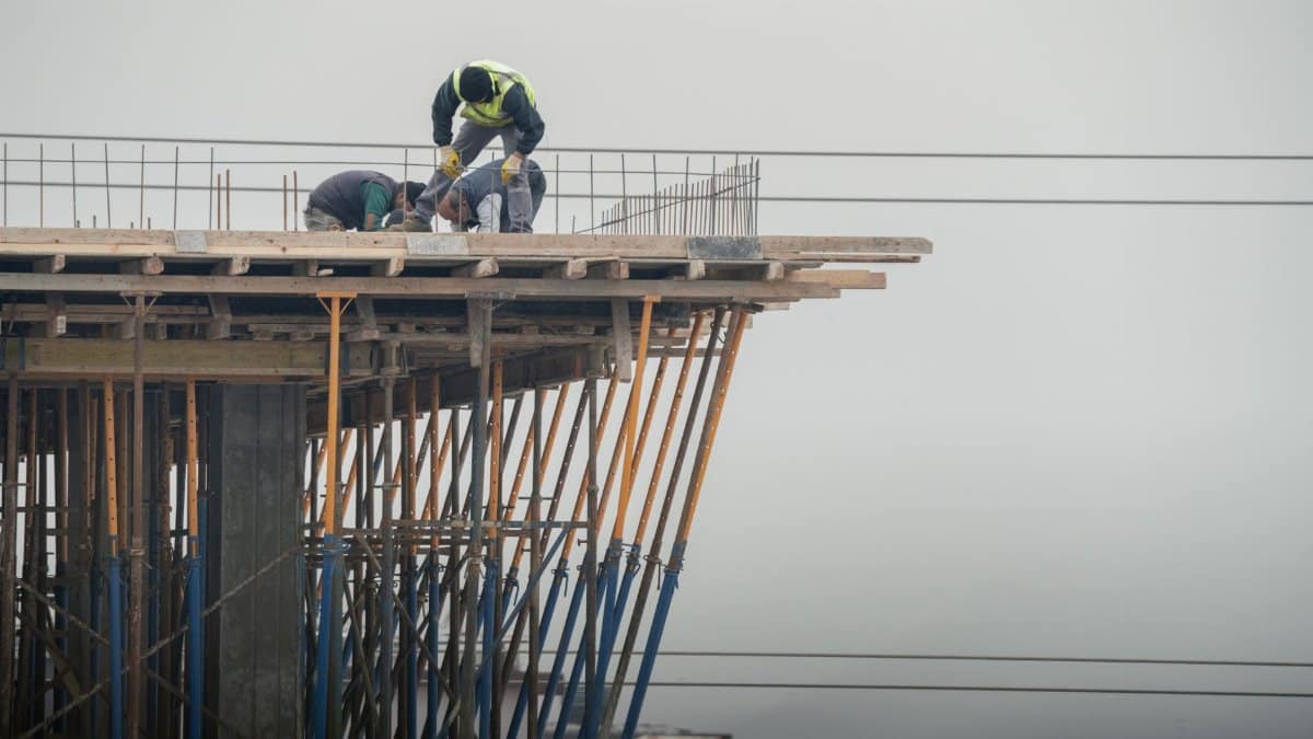 Workers on a high-rise building construction site in Denizli, Türkiye, showcasing teamwork and safety.