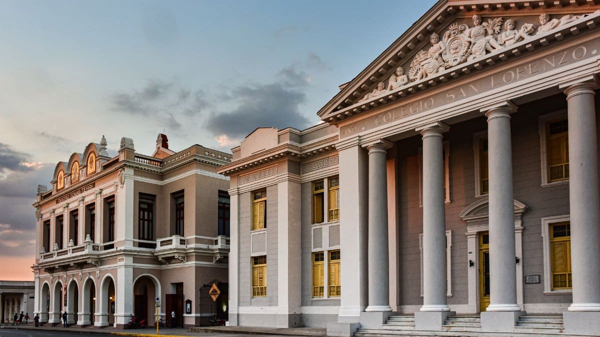 Elegant facade of Colegio San Lorenzo with classical architecture at sunset in Cienfuegos, Cuba.