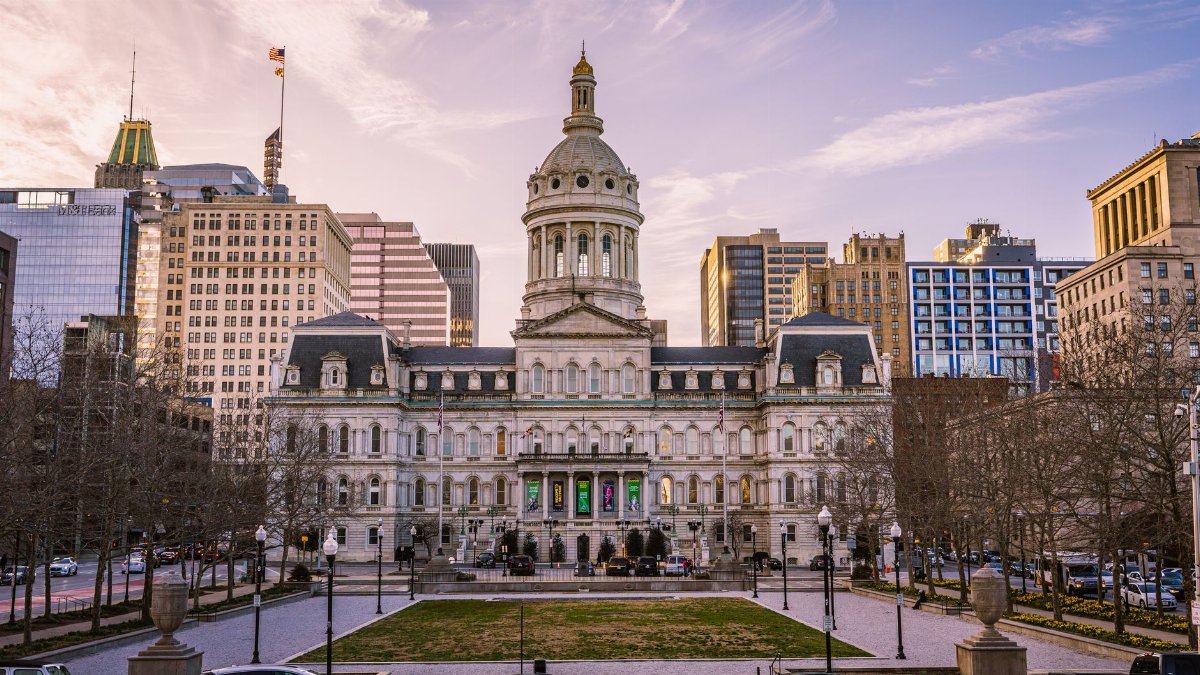 Majestic view of Baltimore City Hall with the city skyline during daytime.