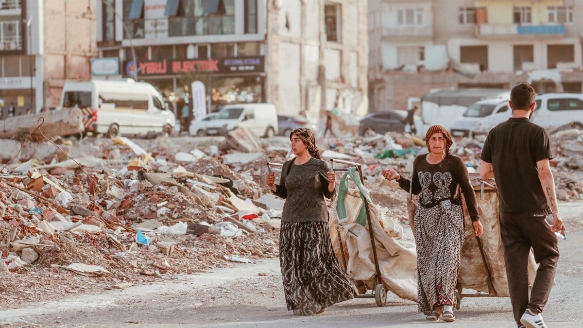 People navigating ruins in an urban area showcasing resilience amid destruction.
