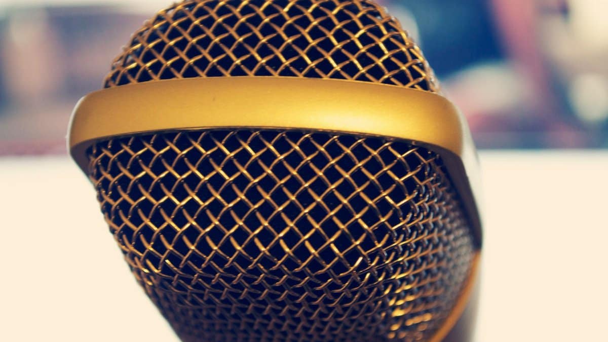 Elegant close-up of a gold microphone, perfect for audio and music themes.