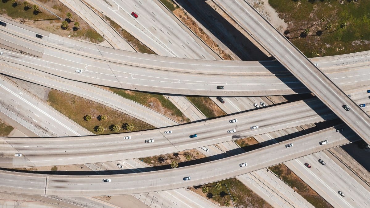 Aerial shot of a multi-level highway interchange showcasing urban traffic patterns.