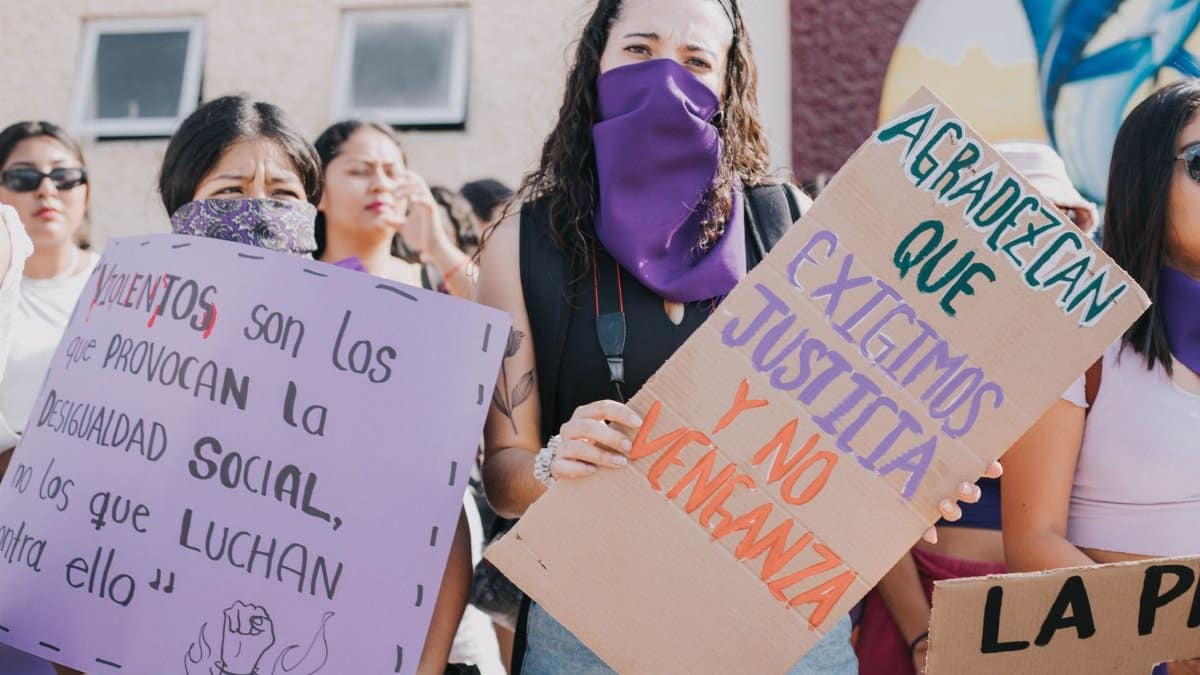 A group of women at a protest holding signs advocating for social equality and justice.