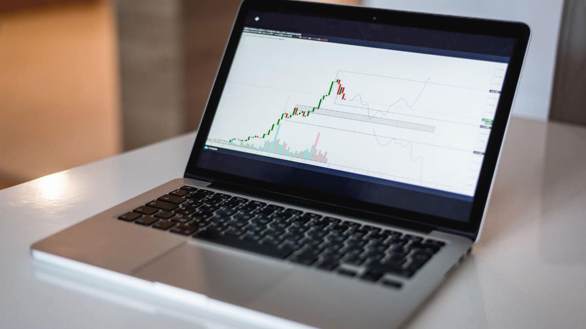 Close-up of a laptop showing a financial trading graph, ideal for finance and technology themes.