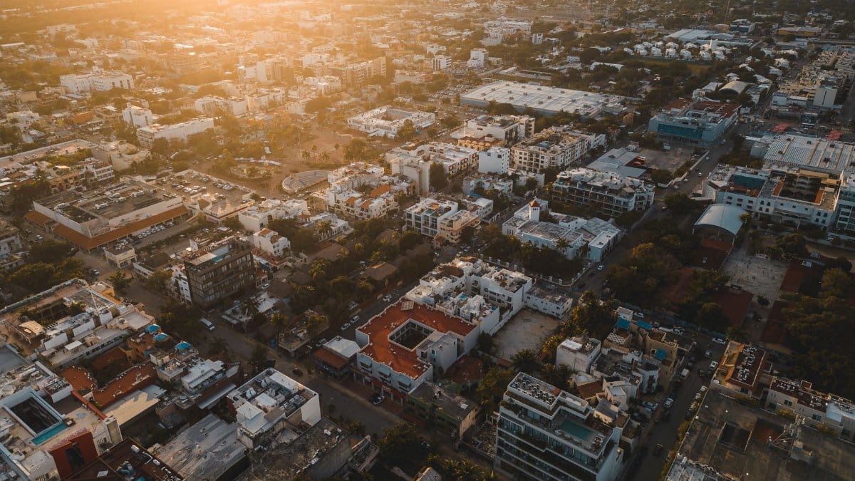 Stunning aerial cityscape of Playa del Carmen, Mexico at sunset, capturing urban life and architecture.