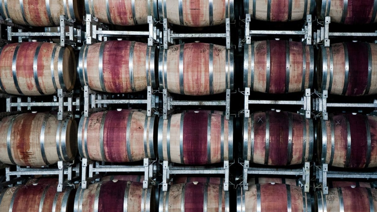 Stacked wooden barrels in a winery store wine, highlighting the art of winemaking.