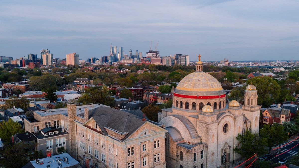 Stunning aerial shot of Philadelphia skyline featuring a historic church under a clear sky.