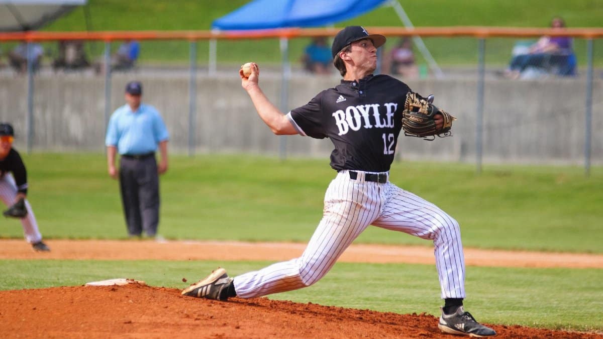 Dynamic shot of a baseball pitcher mid-throw during a daytime game.