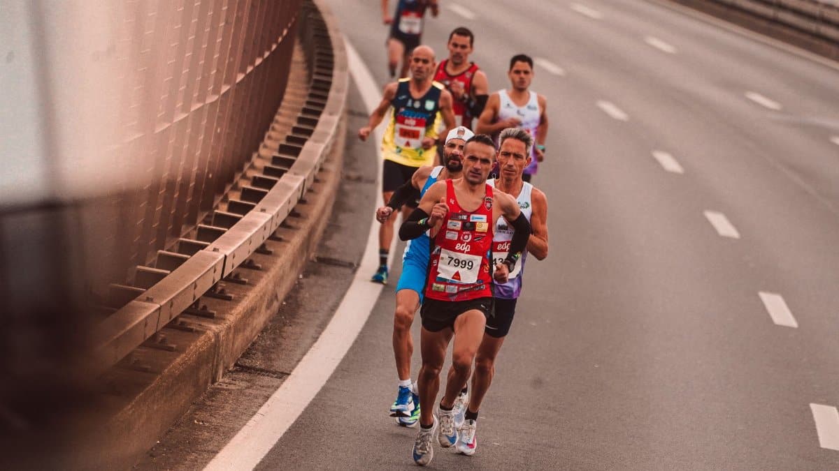 A group of male athletes competing in a city marathon, featuring diverse runners and dynamic movement.